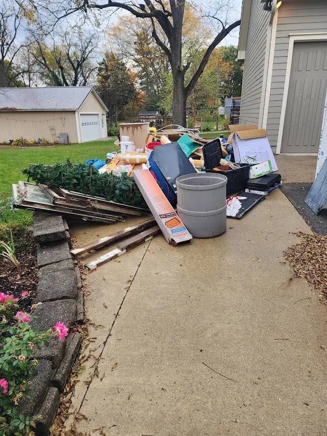 Dumpster being loaded with debris for Roofing Dumpster Rental in Oswegatchie